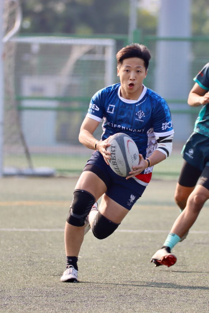 athlete running with rugby ball